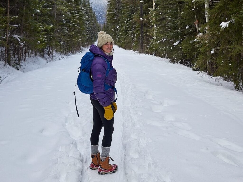 BFT founder Kristen Bor hiking in the snow on the Golden Wapta Falls Trail. She is wearing warm hiking gear including a puff jacket and winter boots.