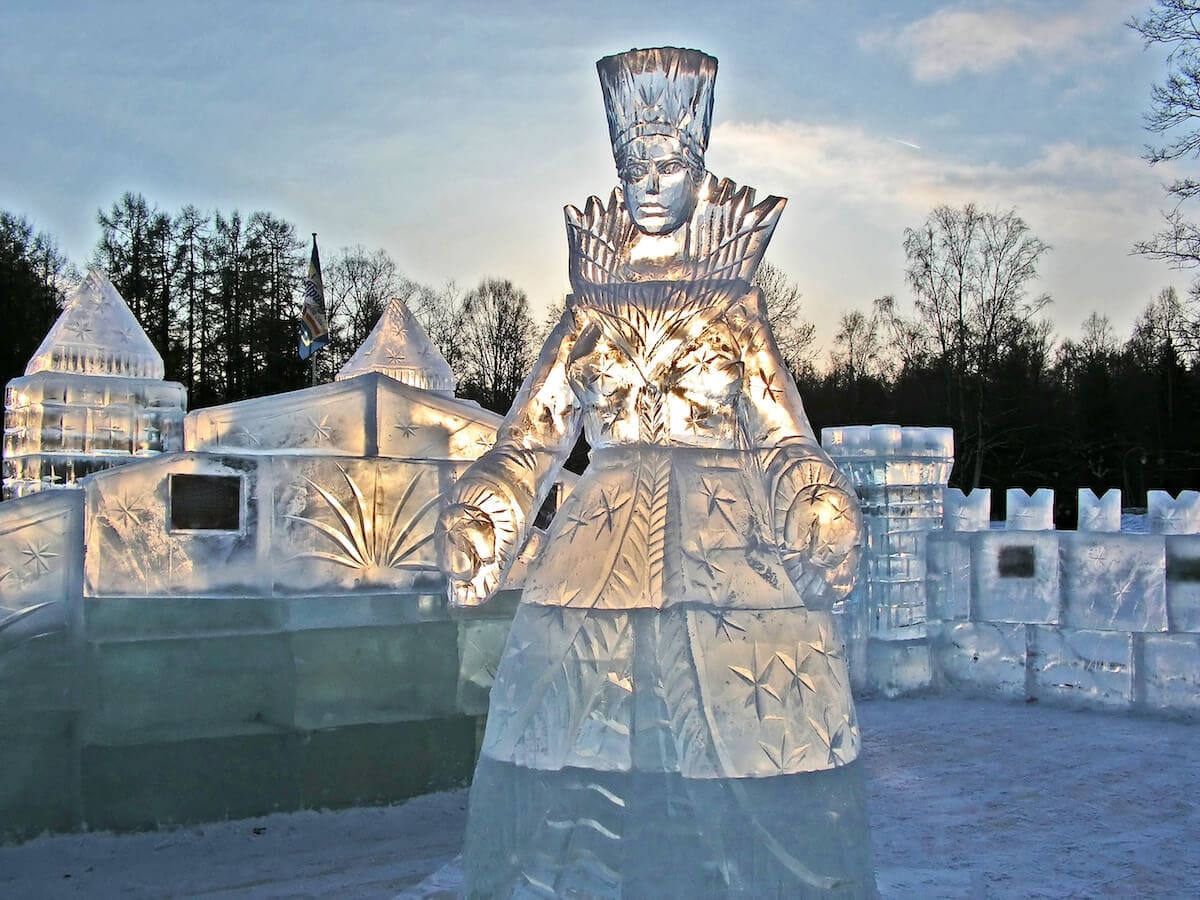 an ice sculpture of a queen with various ice sculptures in the background