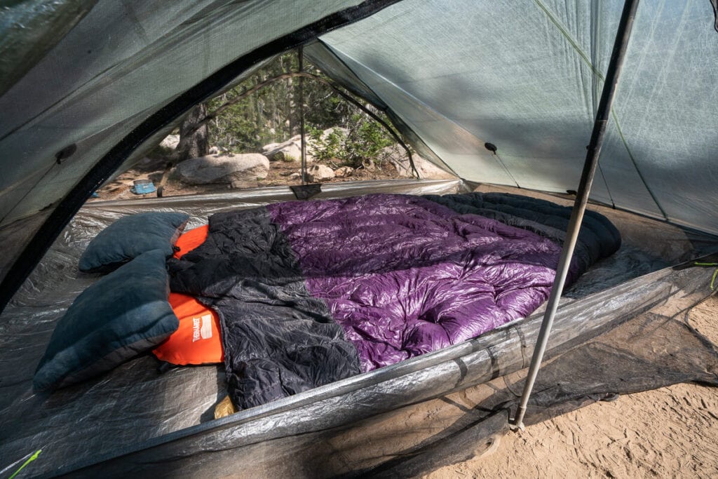 Enlightened Equipment two person sleeping quilt for backpacking laid out in tent