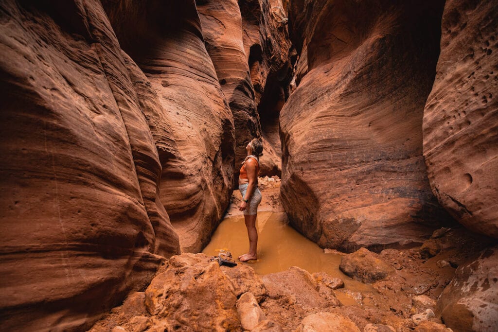 Woman stands in Buckskin Gulch slot canyon in Utah