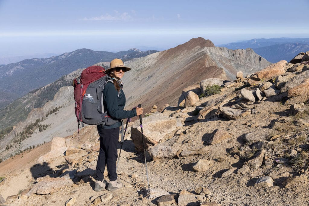 woman wearing a red backpacking backpack and Mountain Hardwear Dynama/2 Ankle Pants in Sequoia National Park