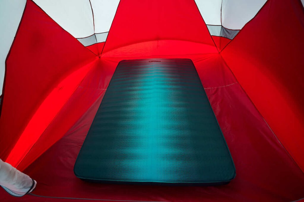 The NEMO Roamer Double Sleeping Pad inflated in a red camping tent