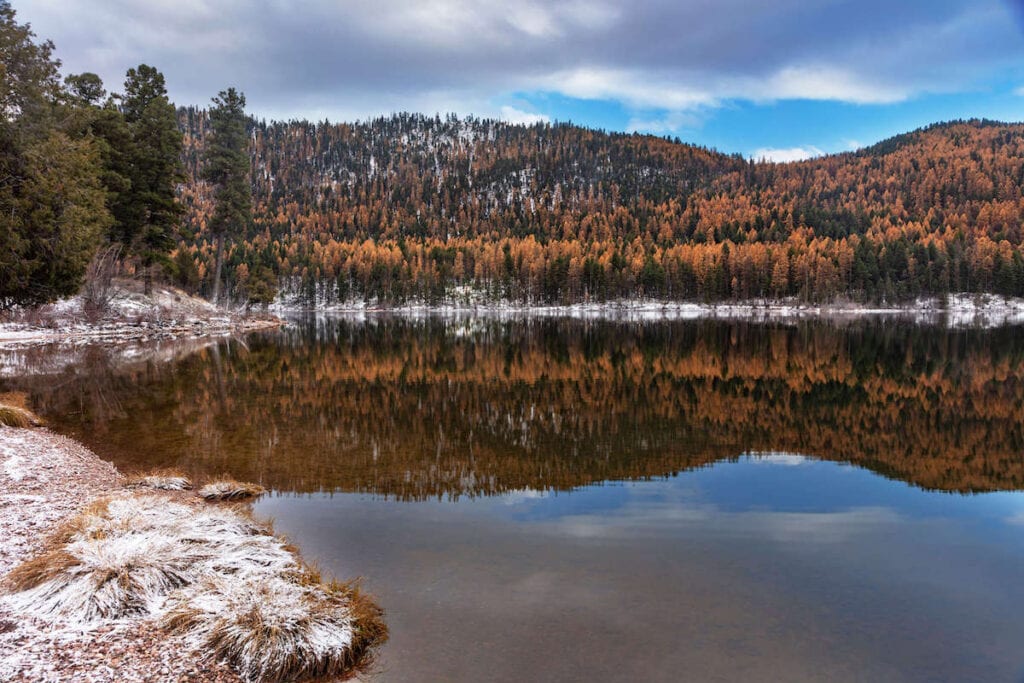 Picturesque Salmon Lake in Montana in late autumn with fall foliage and a dusting of snow