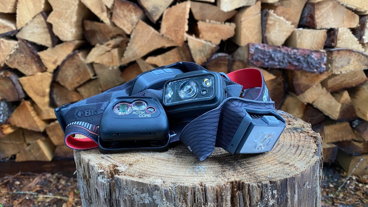 Headlamps sitting on a wood stump