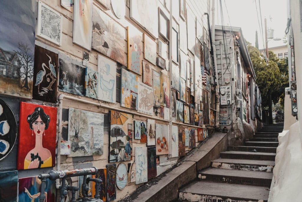 Wall of art lining one side of stair alleyway of Bisbee, Arizona