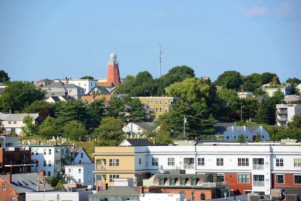 The Portland Observatory on hill above houses and buildings in Portland, Maine