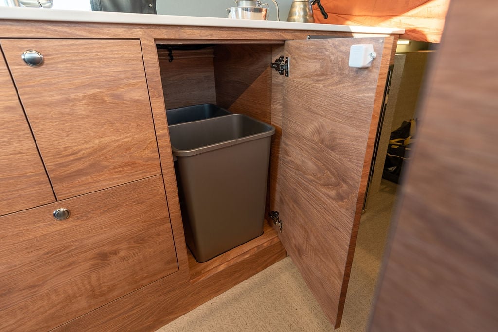 Trash compartment in a Sprinter Van conversion