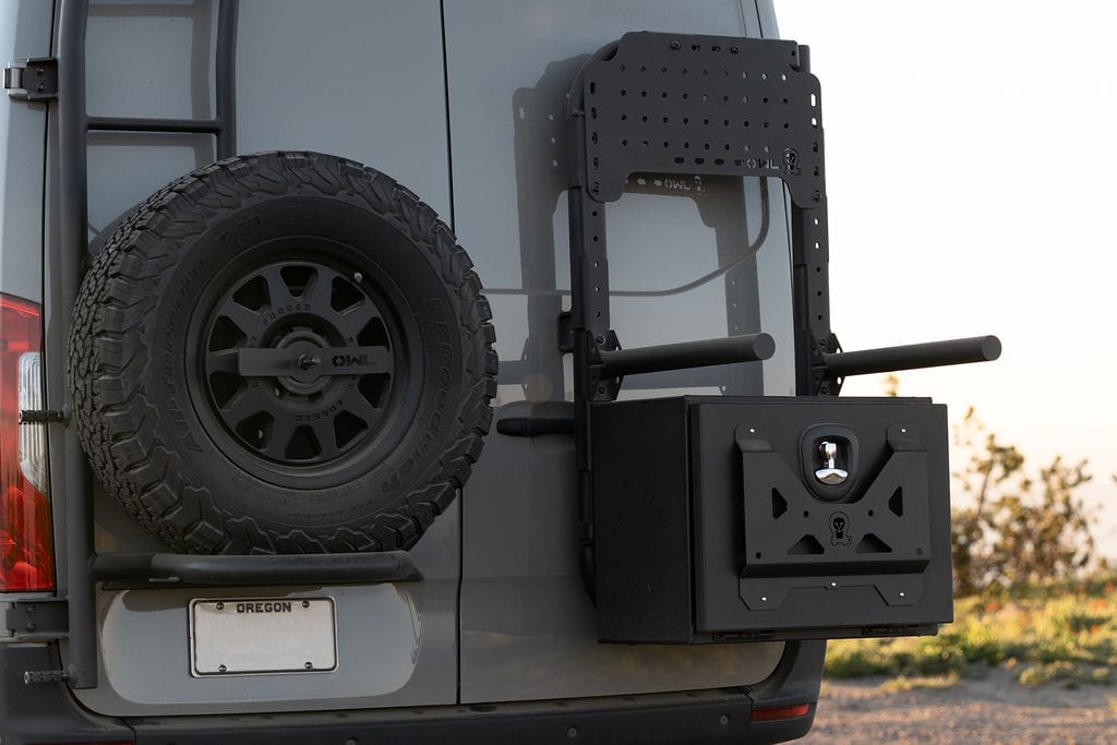 Owl Engineering Ladder, Spare Tire rack, B2, Medium Expedition Box, and Mini Sherpa plate on the back of a 4x4 Sprinter Van designed for outdoor adventure