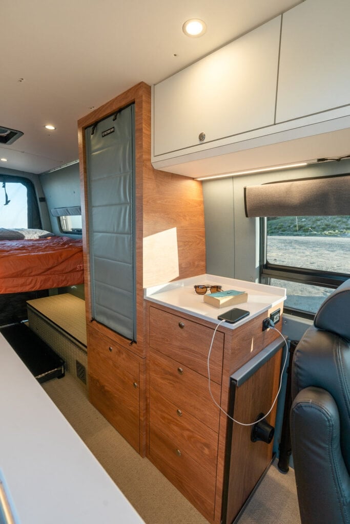 Storage and closet in a 170" sprinter van conversion built by Outside Van