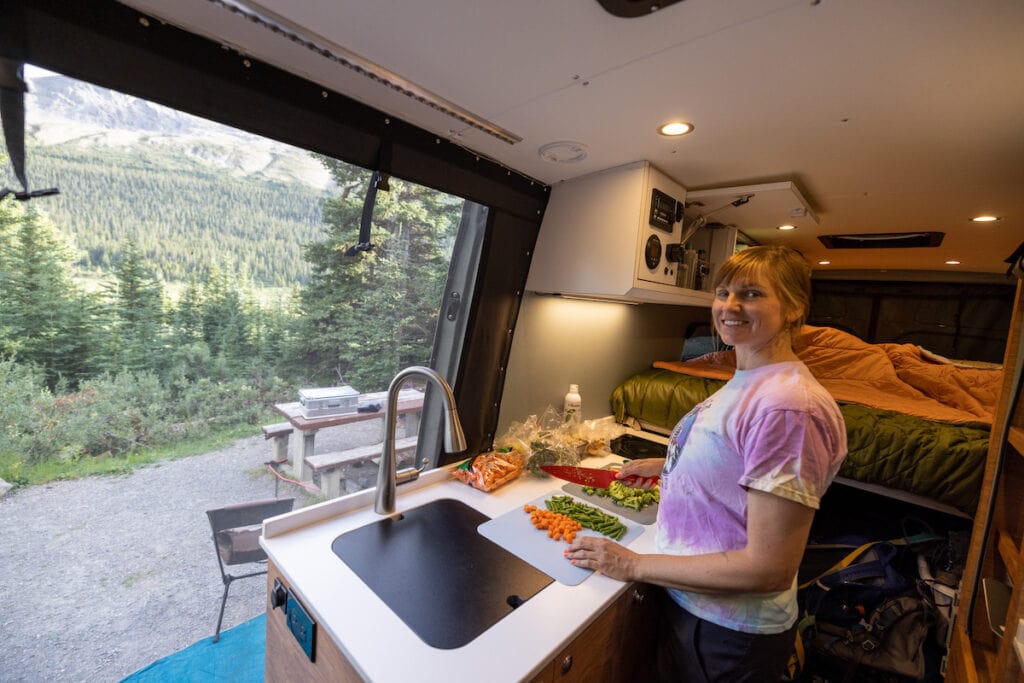 Kristen Bor cooking in a sprinter van