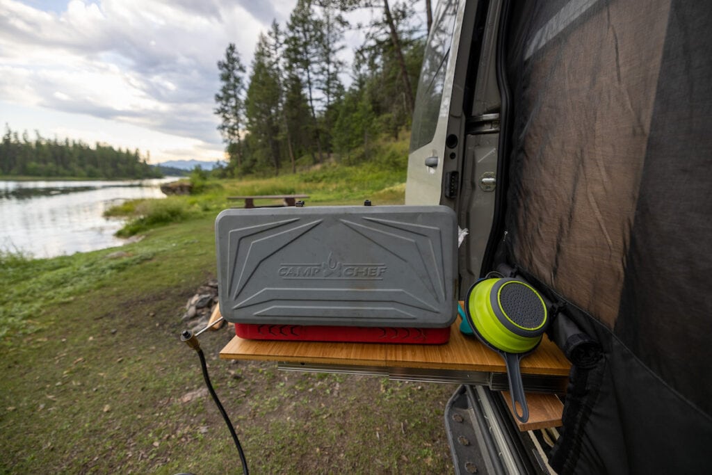 Slide out table that comes out from a galley in the slider door of a sprinter camper van