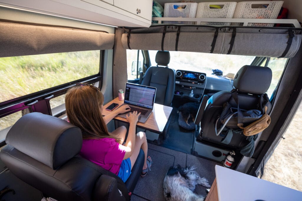 4x4 Sprinter Van Conversion built by Outside Van with a third passenger seat that doubles as a desk and dining area