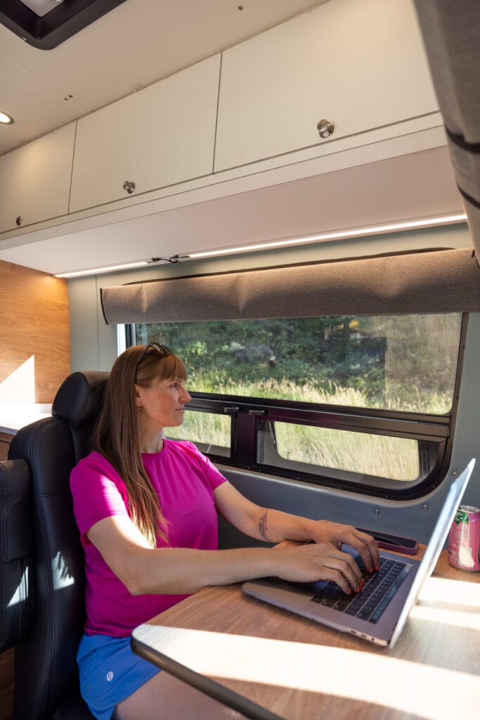 4x4 Sprinter Van Conversion built by Outside Van with a third passenger seat that doubles as a desk and dining area