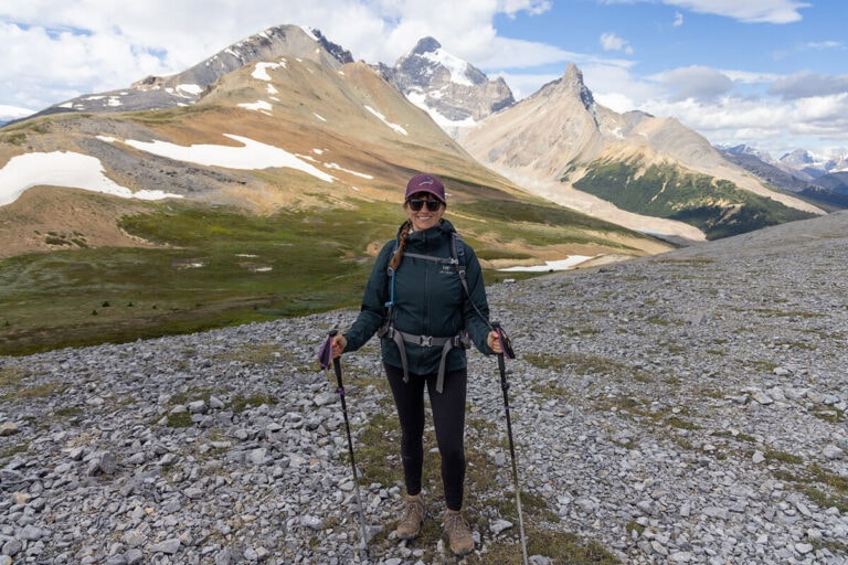 Bearfoot Theory outdoor blog founder Kristen hiking in the mountains in Banff National Park wearing an insulated jacket, leggings, hiking boots, and a hat