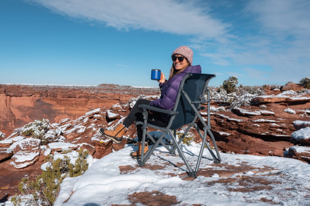 A woman sits in the YETI Trailhead Camp Chair in snowy Moab Utah