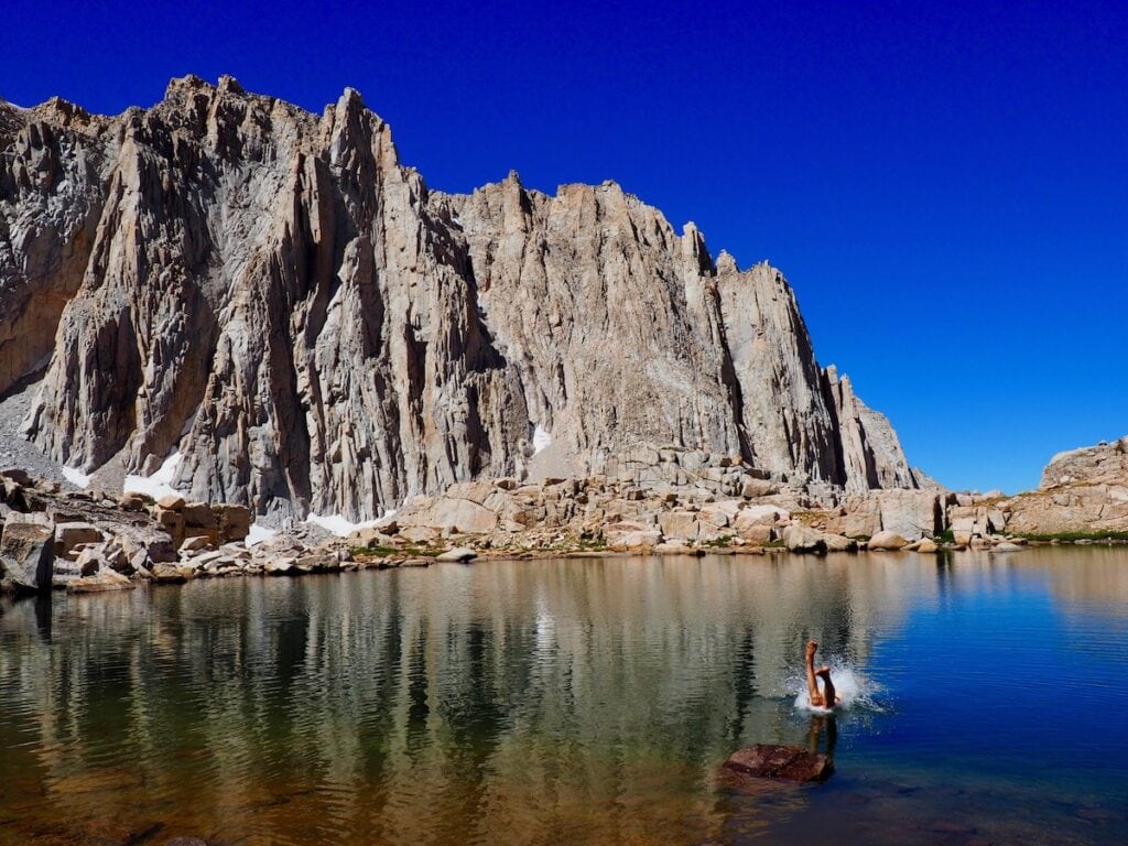 A man jumps into Hitchcock Lake a detour from the John Muir Trail