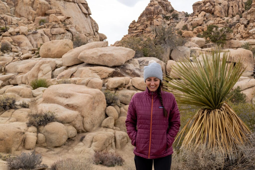 A woman wearing the Patagonia Nano Puff Jacket in Joshua Tree