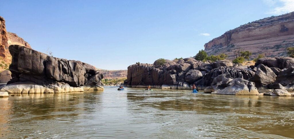 Paddlers floating through narrow Black Rock section of Colorado River 