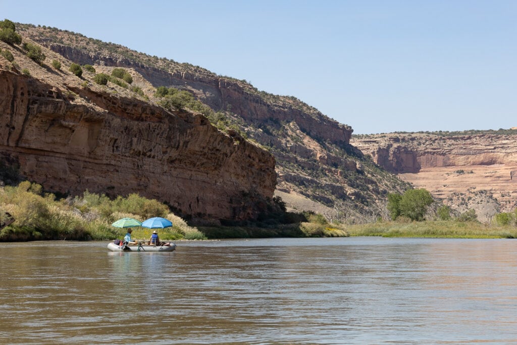 A raft floating through Ruby-Horsethief Canyon on the Colorado River