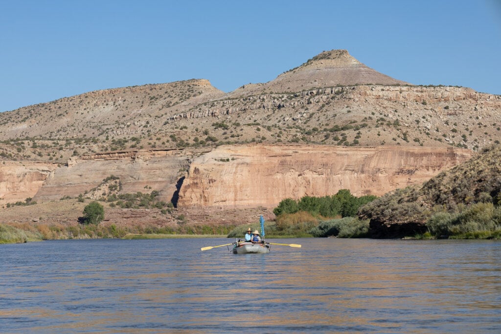 A raft floating through Ruby-Horsethief Canyon on the Colorado River