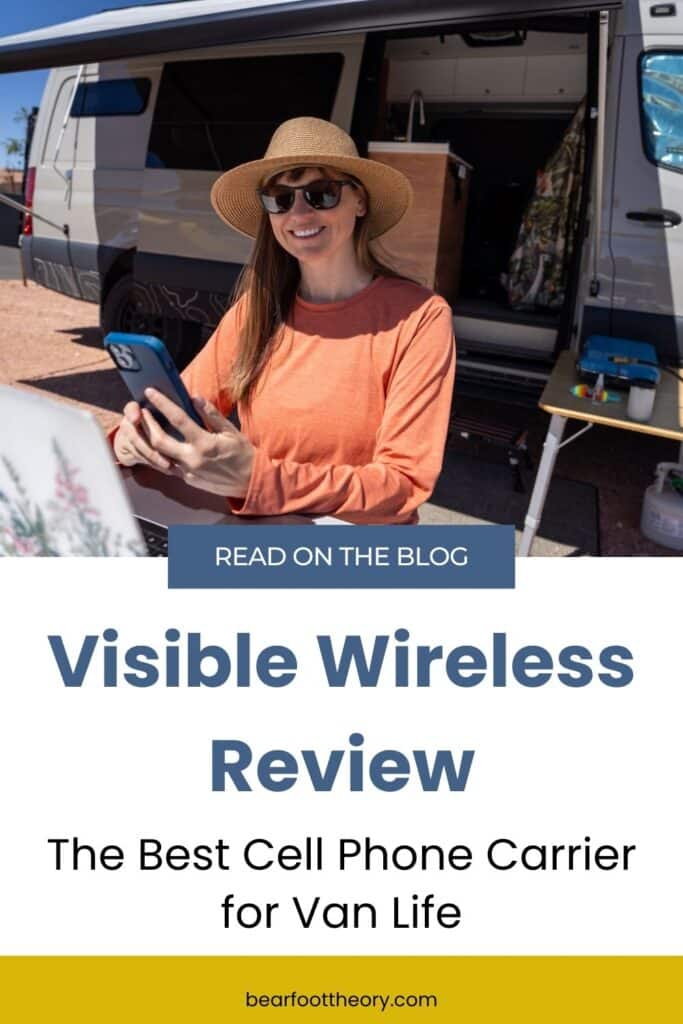 Kristen Bor with a laptop and her phone in her hand sitting at a picnic table that is next to a sprinter van. Text reads Visible Wireless Review - the best cell phone carrier for van life"