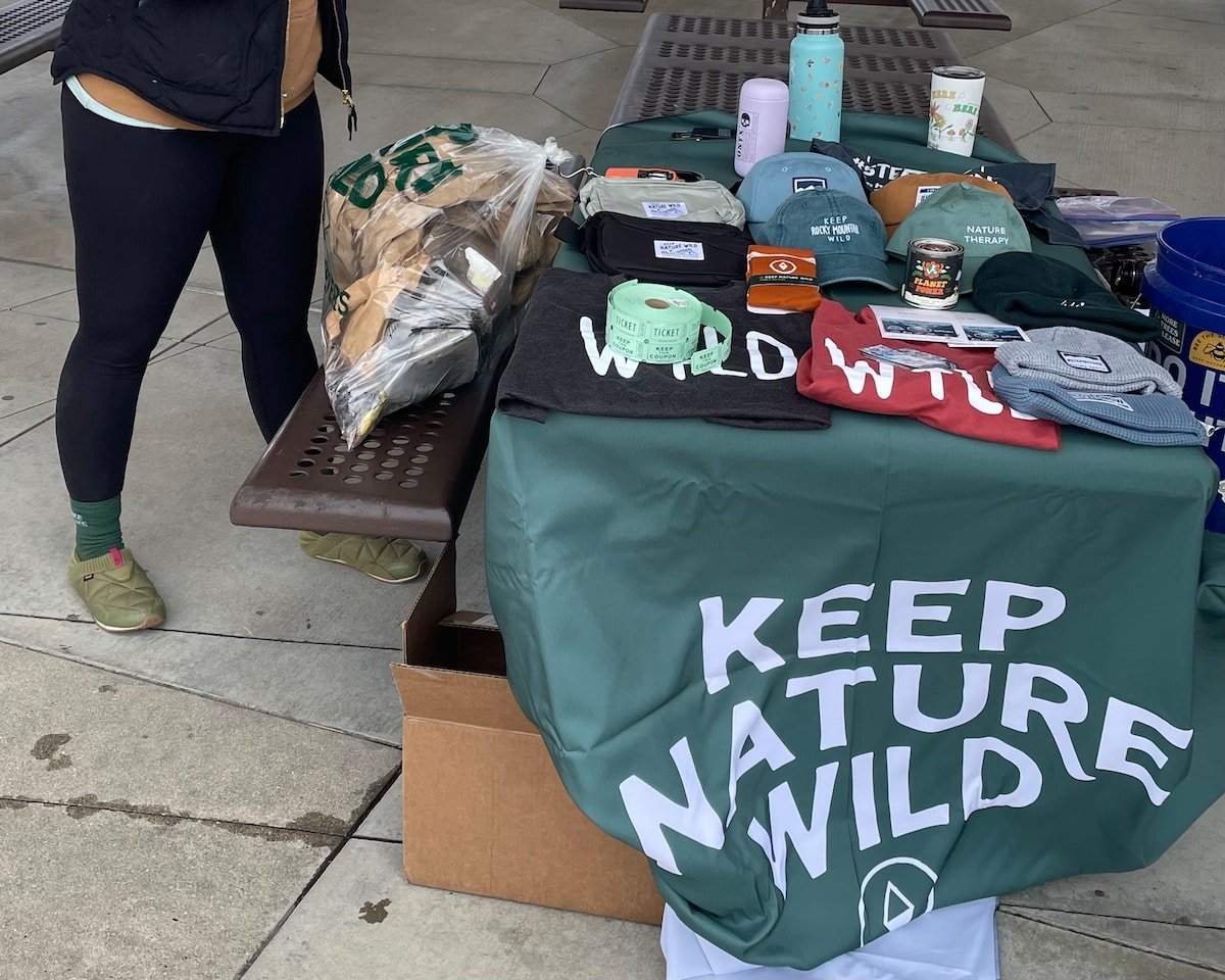 Booth with apparel on top at a cleanup event for Keep Nature Wild