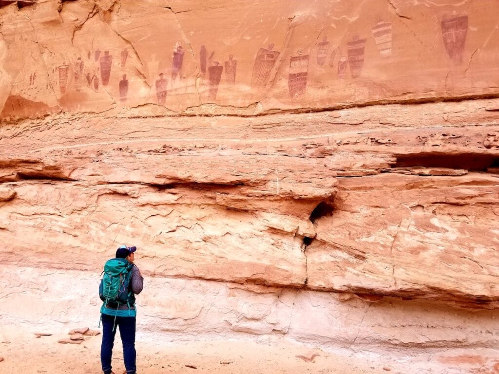 A woman looks at The Great Gallery in Canyonlands National Park