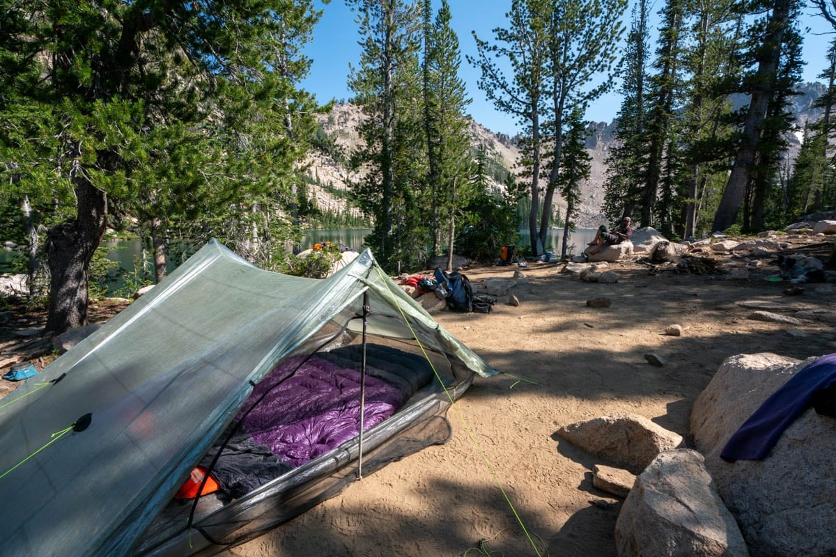 Zpacks tent at a backcountry campsite next to a mountain lake
