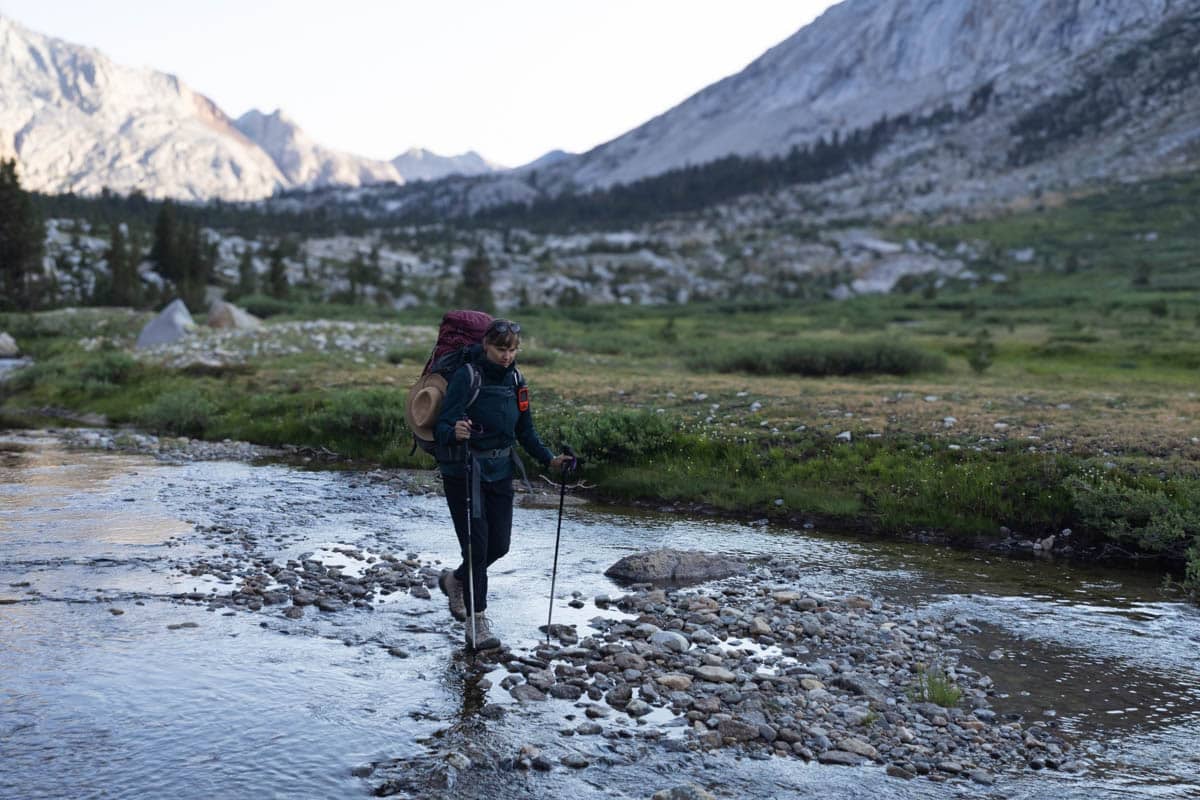 Kristen Bor backpacking across a stream in Sequoia National Park