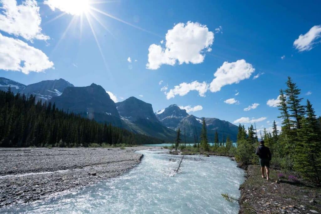 Glacier-fed river in backcountry of Lake Maligne surrounded by tall rocky mountains