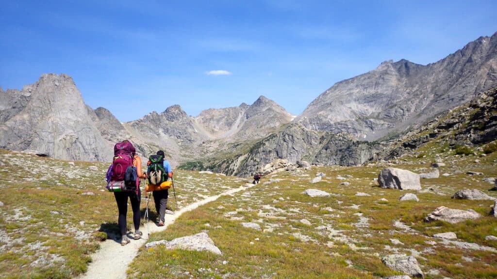 two backpackers hiking over Jackass Pass on Cirque of the Towers, Wyoming