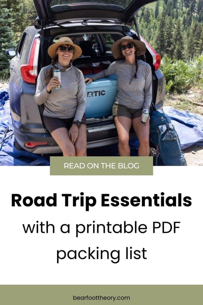 Pinterest pin of two women sitting on the back of a Subaru next to a cooler with the text "Road trip essentials - with a printable PDF packing list"