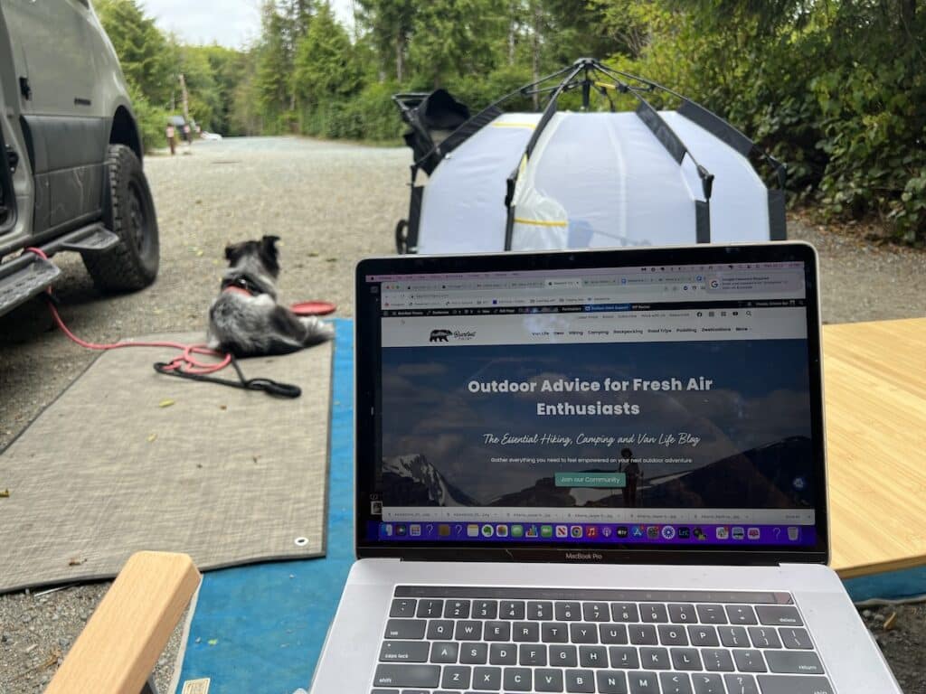 Kristen Bor working on her blog Bearfoot Theory at a campsite