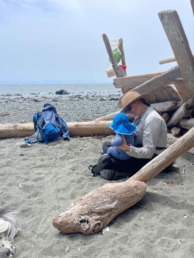 Kristen Bor and her baby sitting on the beach in Juan De Fuca Provincial Park on Vancouver Island