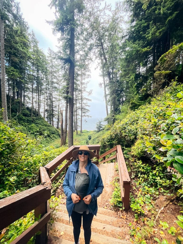 Kristen Bor hiking up a set of stairs in the forest from a beach in Juan de Fuca Provincial Park on Vancouver Island