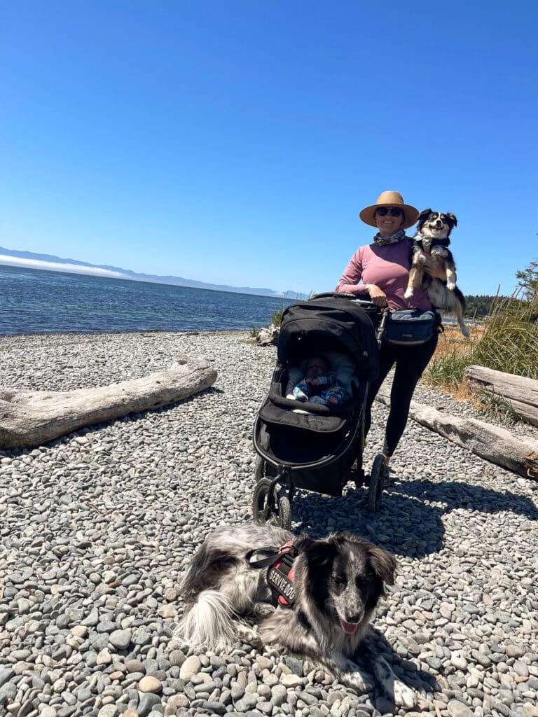 Kristen Bor on the beach  with a stroller and two dogs in Sooke, BC