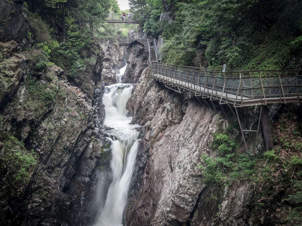 Elevated walkways bolted to rocks above river and gorge on High Falls Gorge Trail in New York