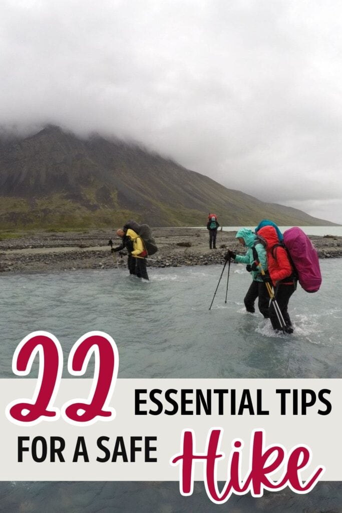 Group of people crossing a river with backpacking packs on with text "22 essential tips for a safe hike"