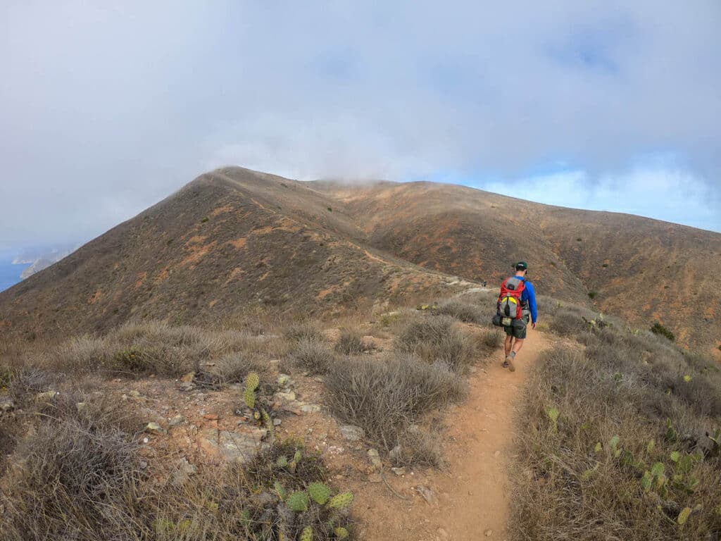 Backpacking hiking on ridge line trail on the Trans-Catalina Route