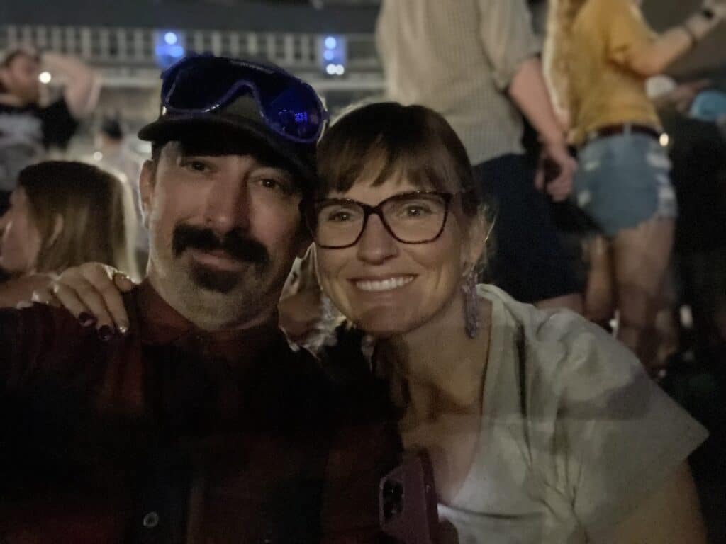 Couple sitting on the floor at a Phish concert