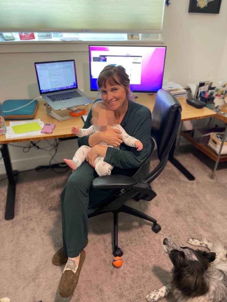 Woman with baby working at desk