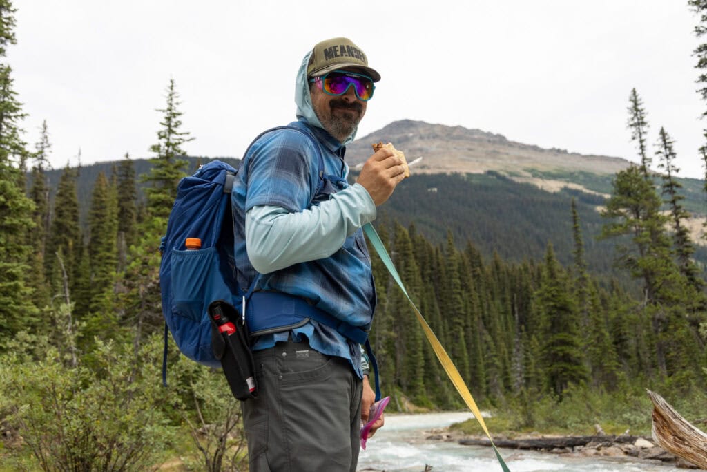 Man with backpack next to a river