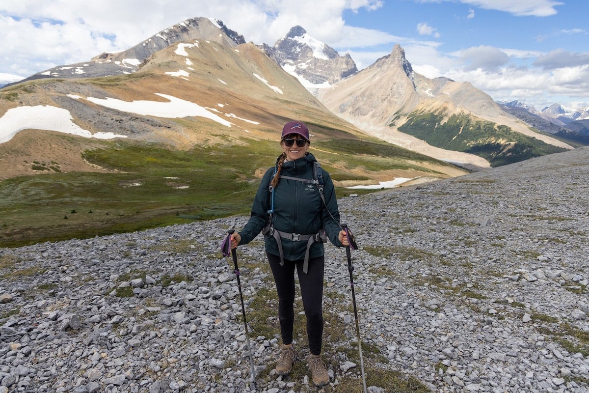 Bearfoot Theory founder Kristen Bor wearing hiking gear on the Parker Ridge Trail in Jasper National Park with snowcapped mountains in the background