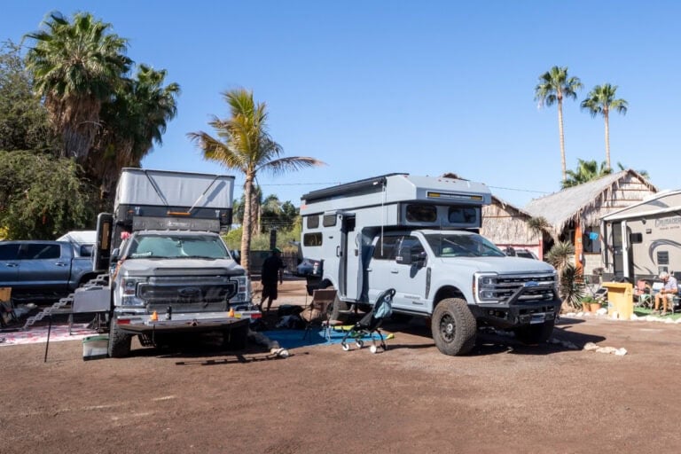 Two truck campers camped next to each other in an RV park