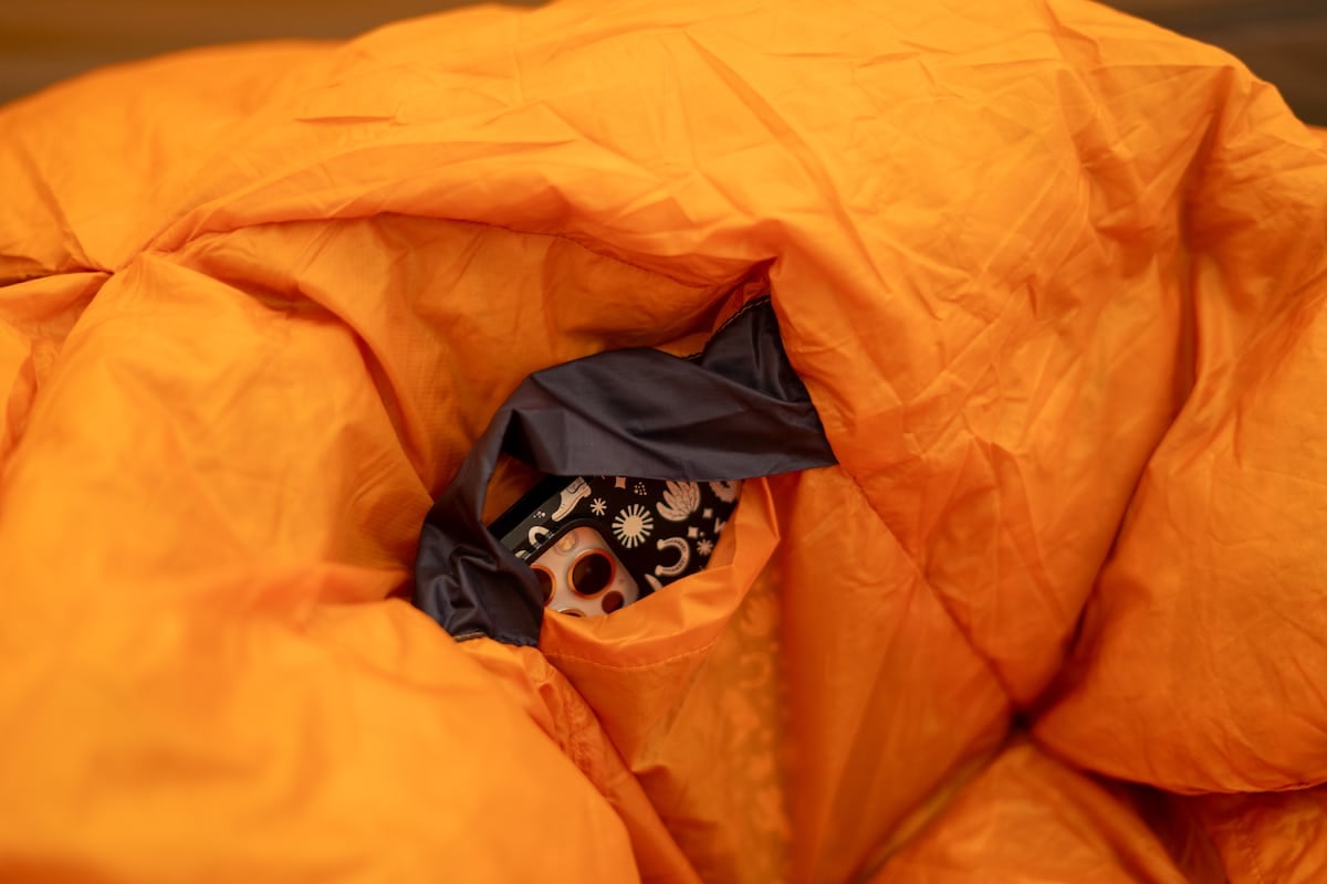 Close up shot of my phone inside of the interior stash pocket of the REI Magma sleeping bag