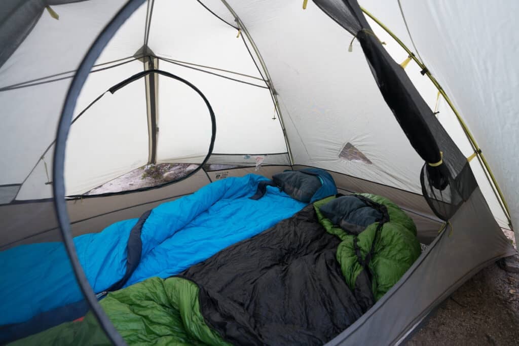 two sleeping bags set up inside a tent