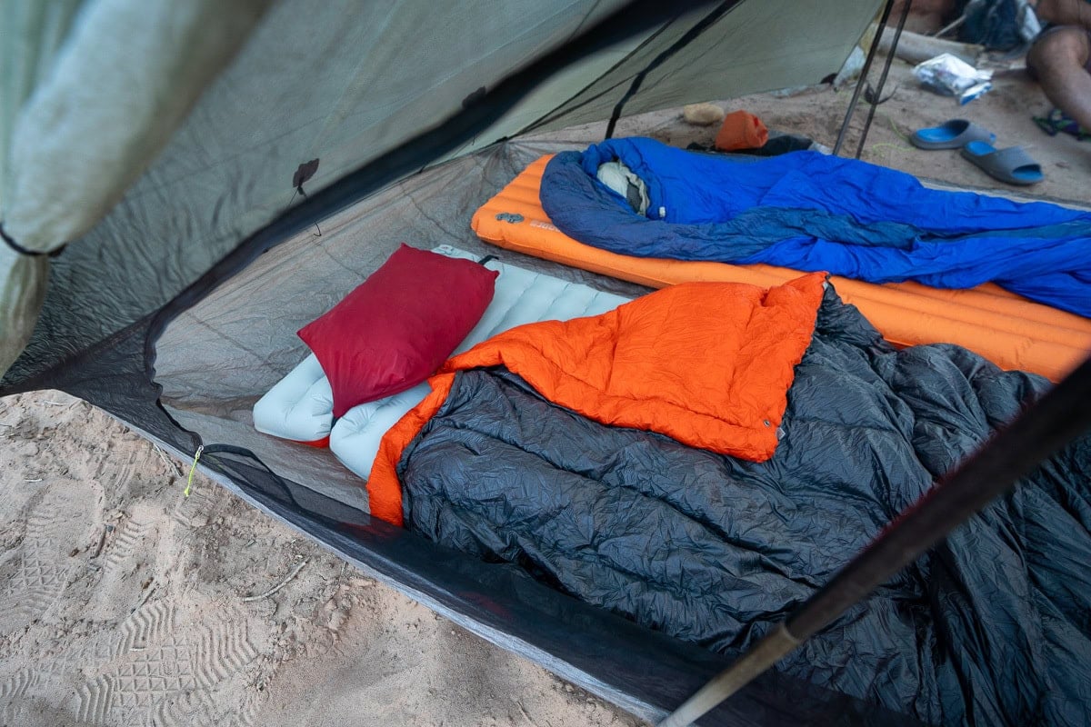 sleeping pads with sleeping bags on top in a tent