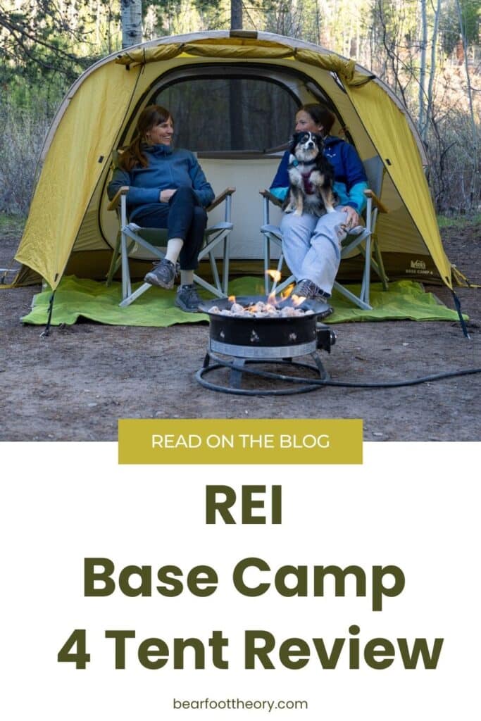 Two women sitting in camp chairs in the vestibule of a tent. Text Reads REI Base Camp 4 Tent Review