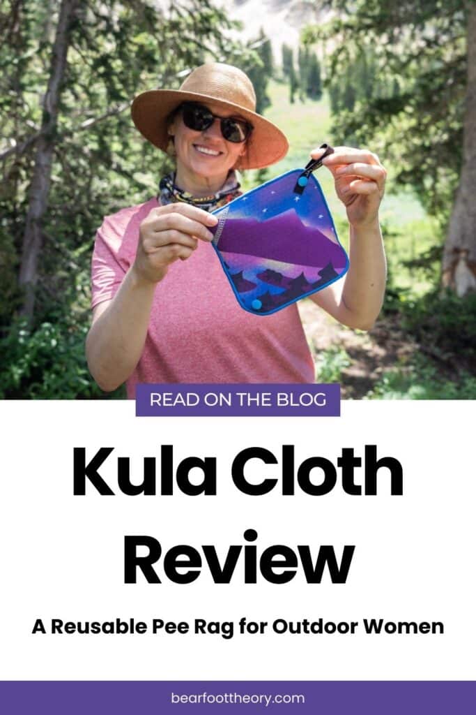 Kristen Bor holding Kula Cloth pee rag featuring a bear next to a lake with a cosmic mountain scene. Text reads Kula Cloth Review. A reusable pee rag for outdoor women