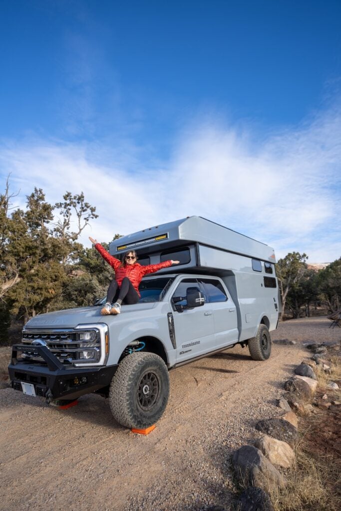 Kristen Bor sitting on the front of the Rossmonster Baja LX Adventure Truck